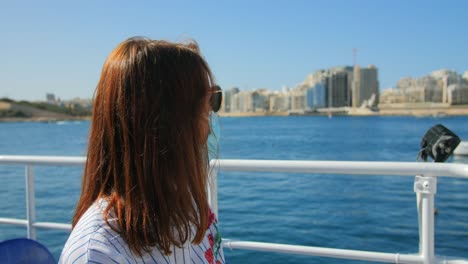 Woman-on-ferry-boat-with-a-surgical-mask-during-Covid-19