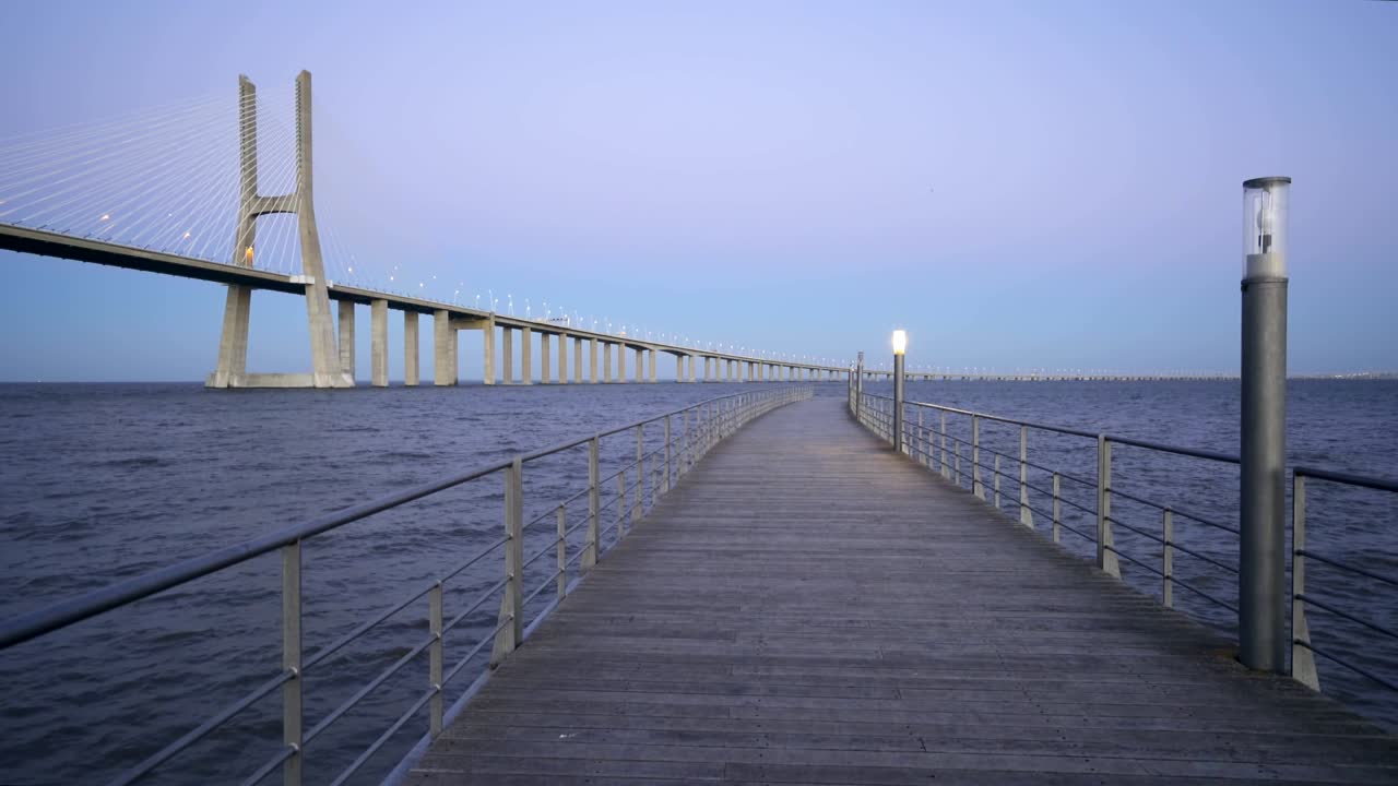 Ponte Vasco da Gama Bridge view from a pier at sunset