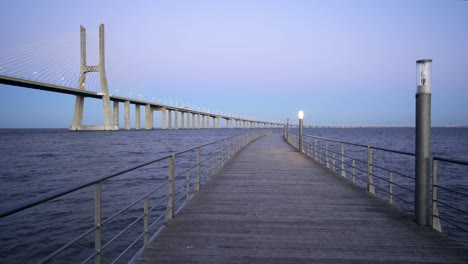 ponte vasco da gama bridge view from a pier at sunset