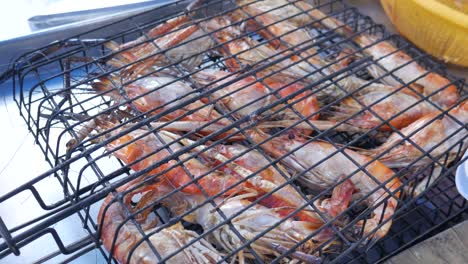 fully-cooked-river-prawns-in-metal-cage-with-charcoal-ready-to-serve-thailand