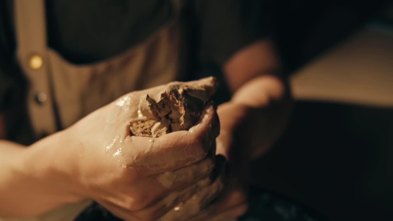 Close-up of hands shaping clay