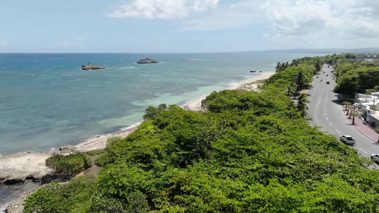 Puerto Plata, beach, coastal road, and modern buildings, Dominican Republic. aerial forward