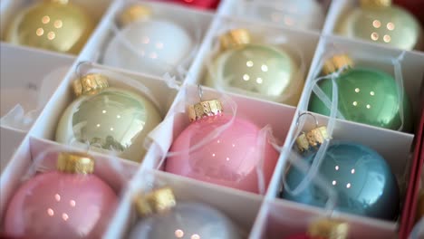 Overhead-perspective-of-shiny,-colorful-Christmas-tree-balls-placed-back-into-a-box