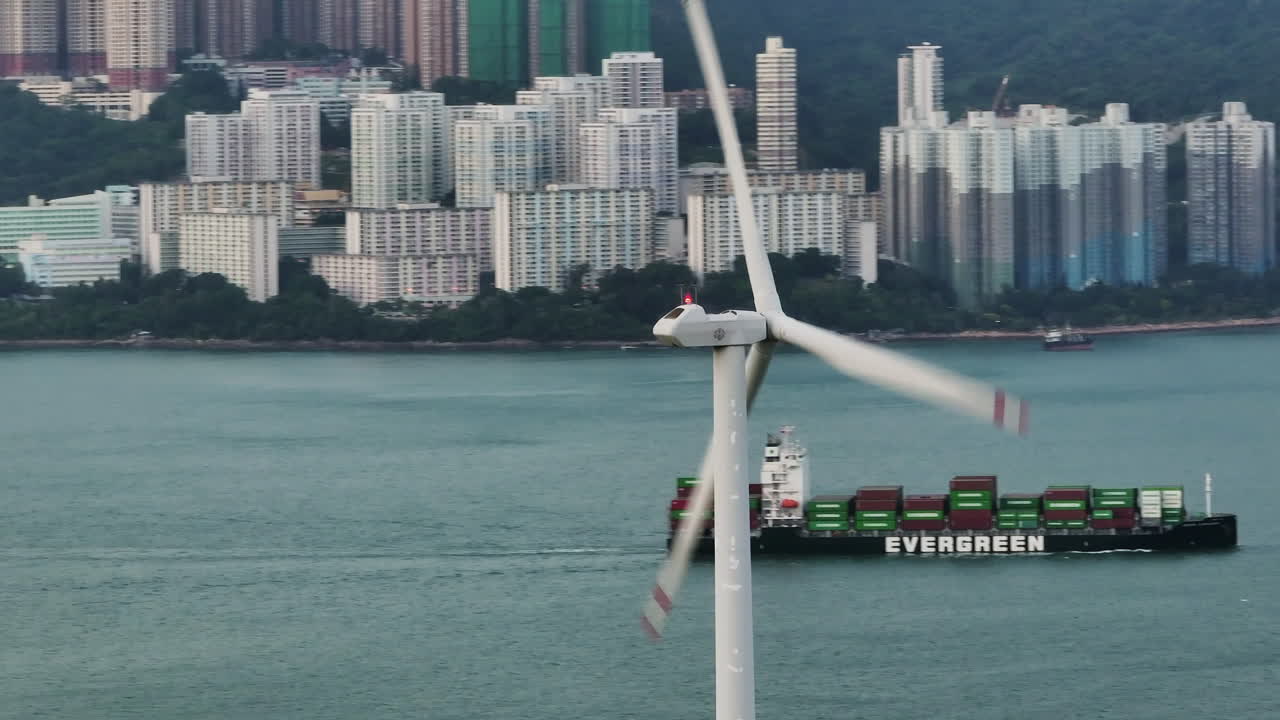 turbina eólica de isla lamma de rápida rotación con la isla de hong kong en el fondo