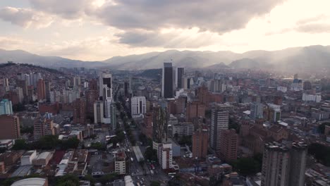 Dusk-light-over-Medellin-high-rises,-Colombia---aerial-fly-over