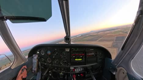 golden hour flight in a general aviation aircraft over northern california’s fields. stunning rural terrain meets vibrant skies in this scenic sunset captured from above