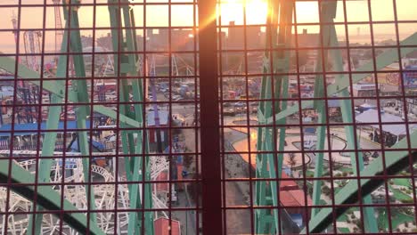 looking out of the ferris wheel at coney island, brooklyn, ny at sunset.