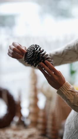 woman holding a pine cone