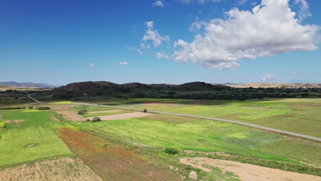 lage cloud shadow moves across open grass landscape of lemnos darkening the green hills