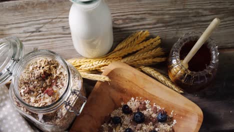 breakfast cereals and jar of honey on wooden table 4k