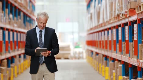 Male-warehouse-manager-using-digital-tablet