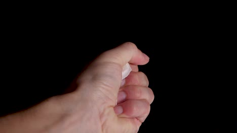 close up of crushing a empty egg shell in a bare fist in slow motion