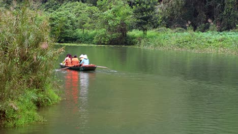 people rowing a boat on a calm river