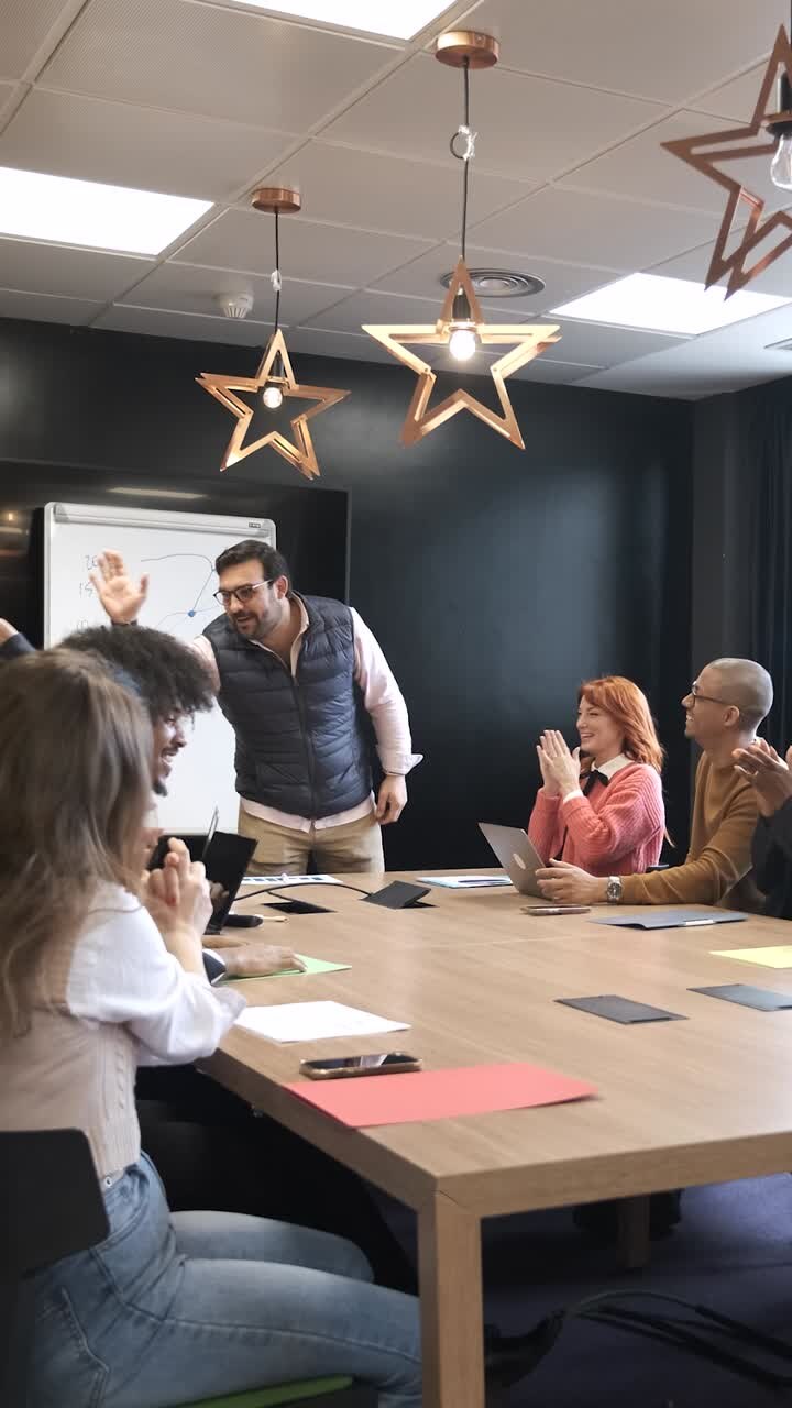 Businessman discussing with colleague during presentation in conference room
