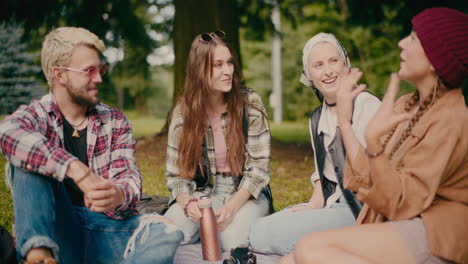 woman talking with friends during picnic at park