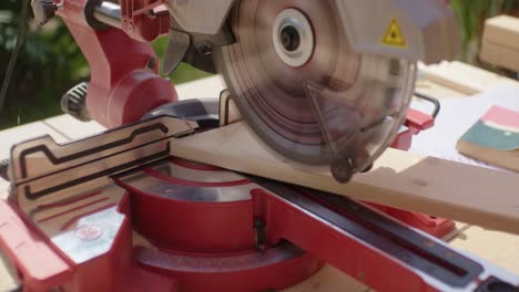 close up of sawing a marked piece of wood to size