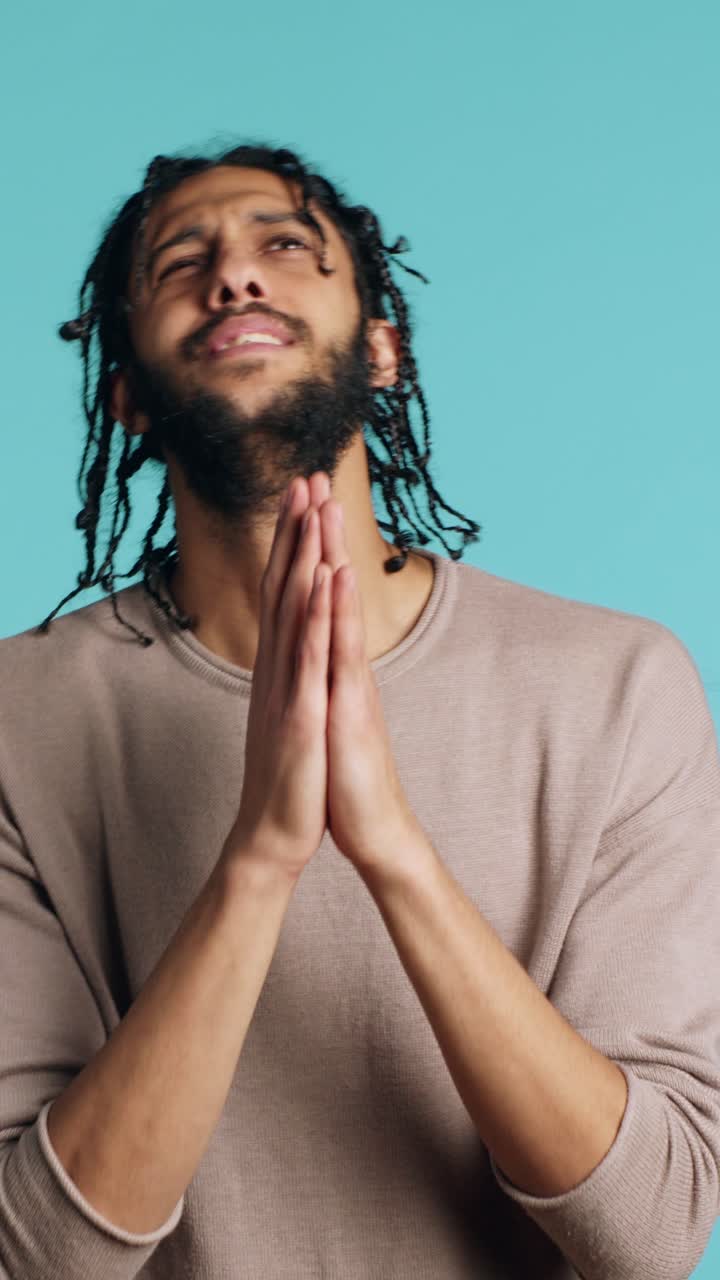 Vertical video Pious man praying to his god, asking for forgiveness, feeling desperate, studio