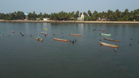 aerial drone shot of a fisherman at work in the ocean near udupi