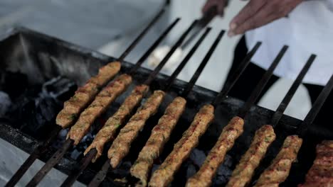 cook making kebabs asian food