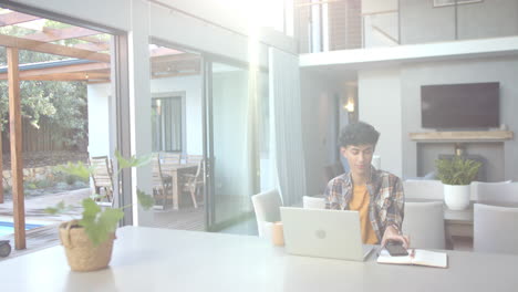 working from home, teenage boy using laptop and mouse in modern living space, copy space