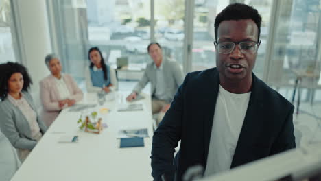 Black-man-at-whiteboard-in-conference-room