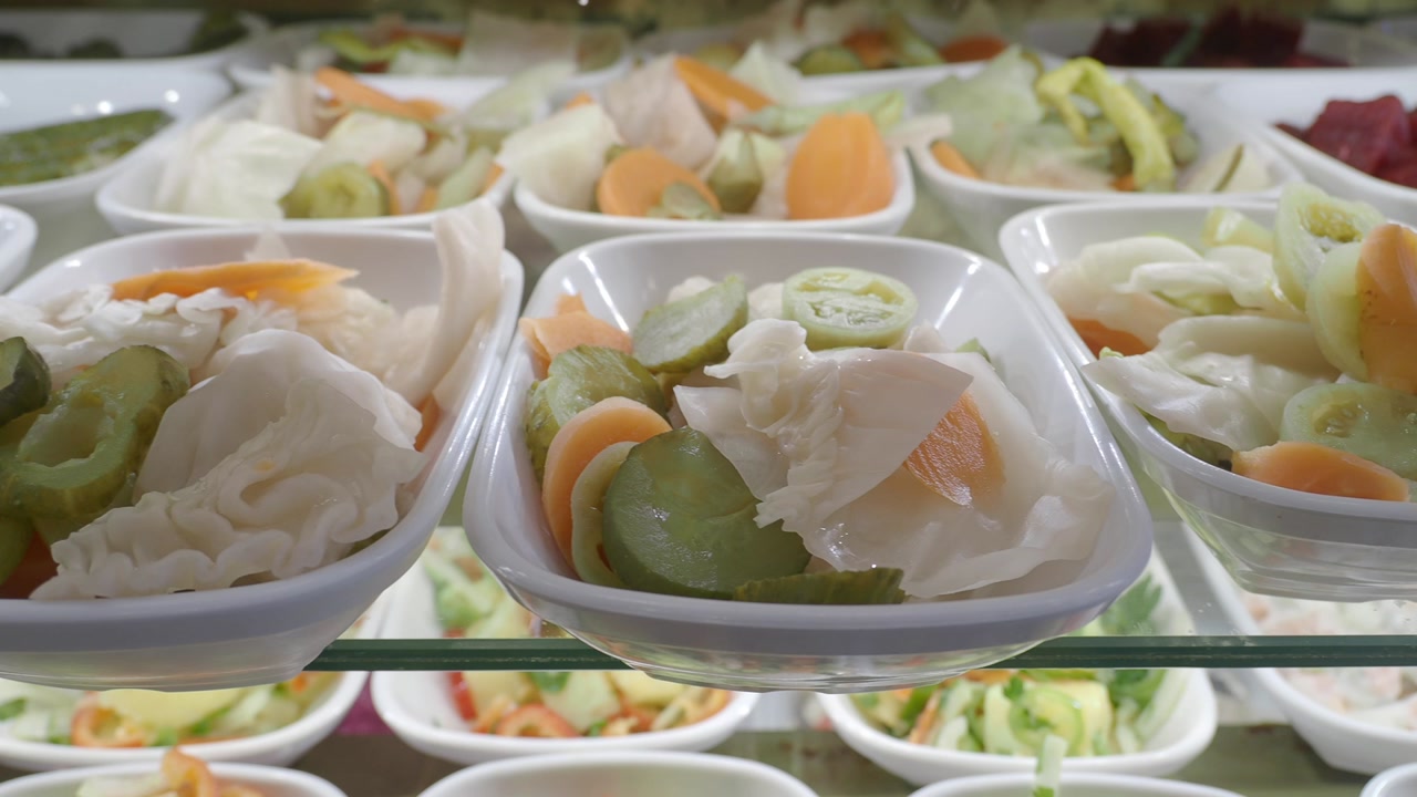Assortment of Pickled Vegetables in Small Bowls on a Restaurant Buffet