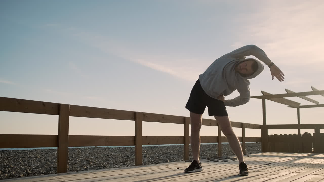 Man Stretching Outdoors on a Pier