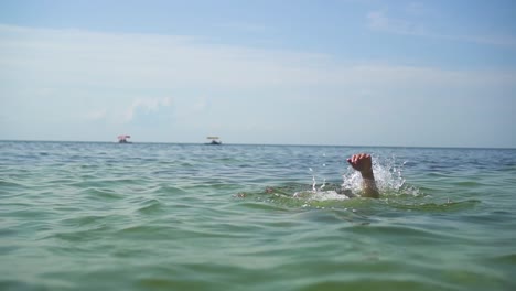 hands of a drowning man in the sea 04