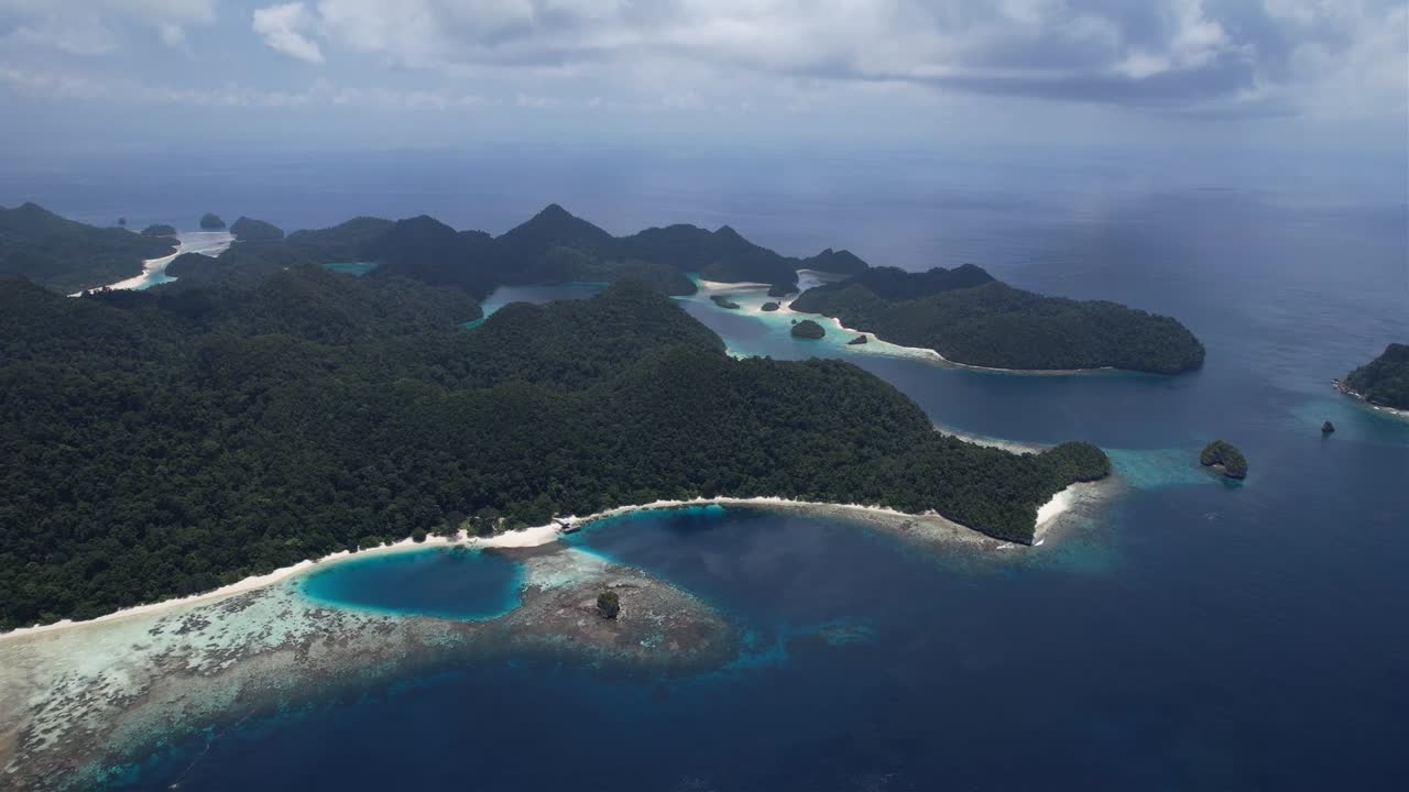 high altitude stunning view on many islands, white sandy beaches, lush green flora, natural lake, coral reefs in Raja Ampat, Wayag, Indonesia, Papua