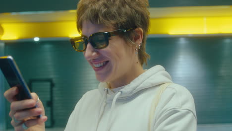 Laughing Girl Using Phone in the Subway