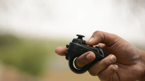 Closeup-of-hand-operating-the-VR-headset-Bluetooth-controller