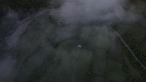 flying over the scenery of syri i kaltër covered with fog and clouds