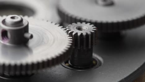 gears rotating in a mechanical device. machine metal gears rotating abstract