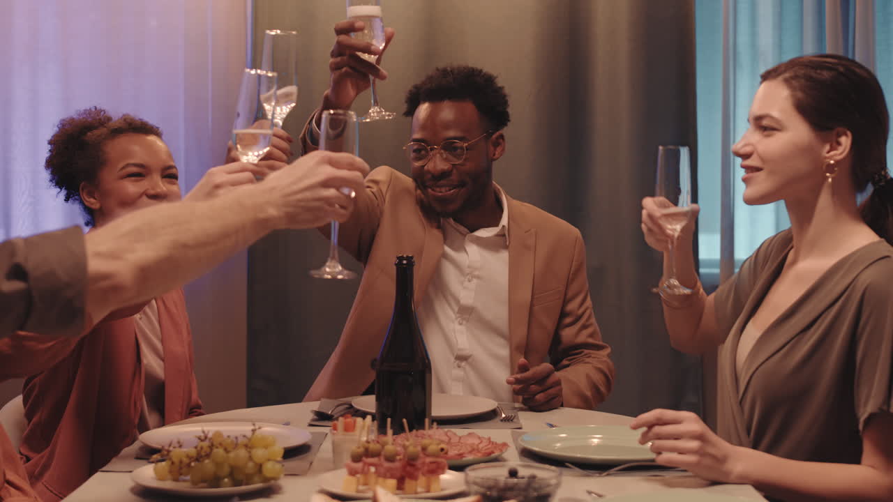 Afro American Man Making Toast at Friends Dinner Party