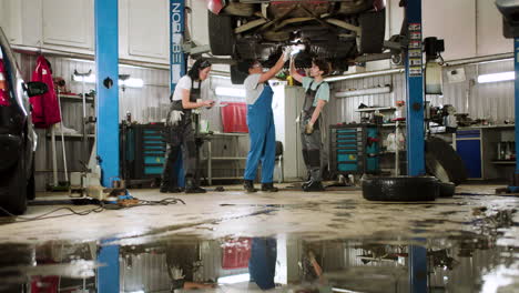 women inspecting vehicle