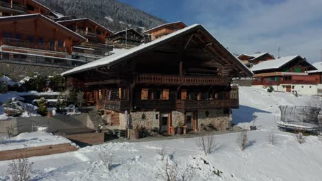 Aerial-overview-of-a-luxurious-vacation-home-with-a-hot-tub-and-trampoline-in-winter