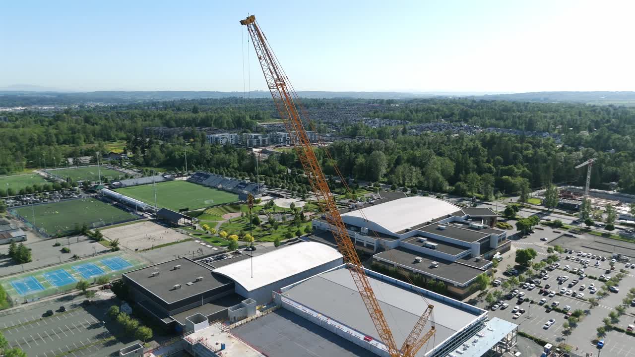 Tower Crane On The Construction Site In Willoughby Suburban Within Langley Township In British Columbia, Canada. Aerial Close-up Shot