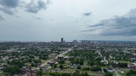 An-aerial-view-of-the-green-city-of-Buffalo,-New-York-with-storm-clouds-in-the-distance