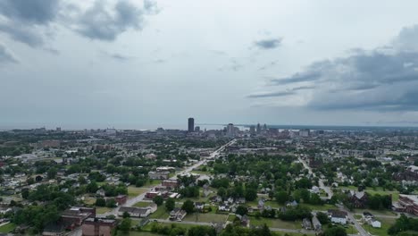 an aerial view of the green city of buffalo, new york with storm clouds in the distance