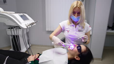 woman having dental treatment in clinic. portrait of friendly woman dentist with patient in the dental office