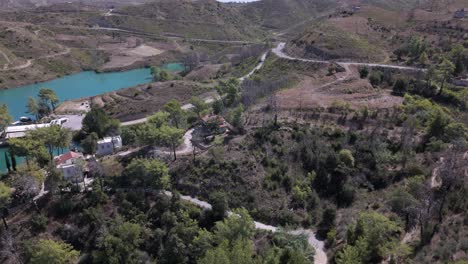 Aerial-establish-of-Green-lake,-Taurus-mountains-Turkey-above-homes-and-settlement