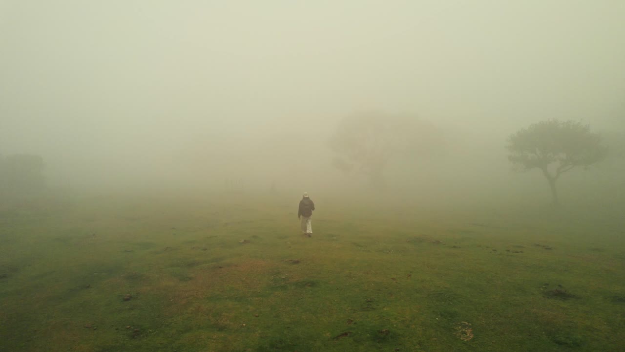 Person Hiking in Dense Fog