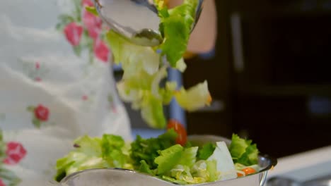 girl preparing salad in kitchen