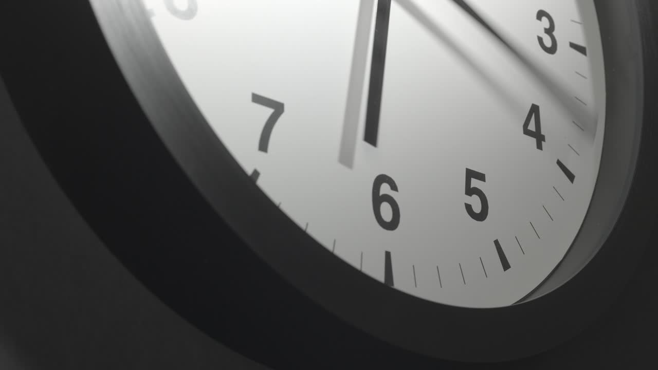 Clock Face in Time Lapse on Dark Grey Wall