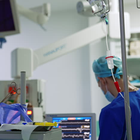 modern medical equipment working in surgery room. male medic stands looking at the monitor.