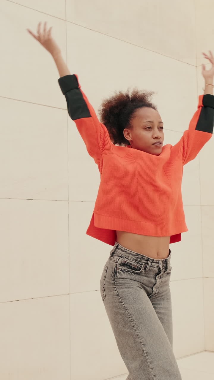 Young Woman Dances Joyfully in Minimalist Setting