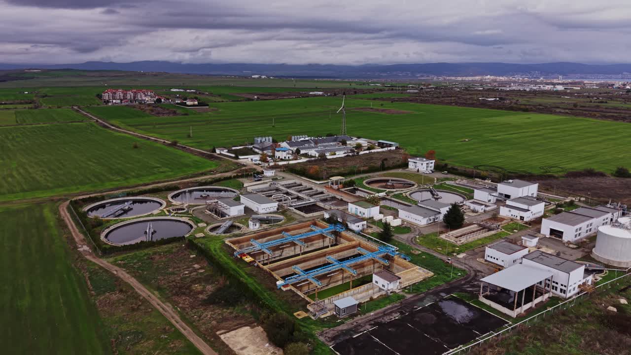 Water treatment facility in a rural area surrounded by green fields