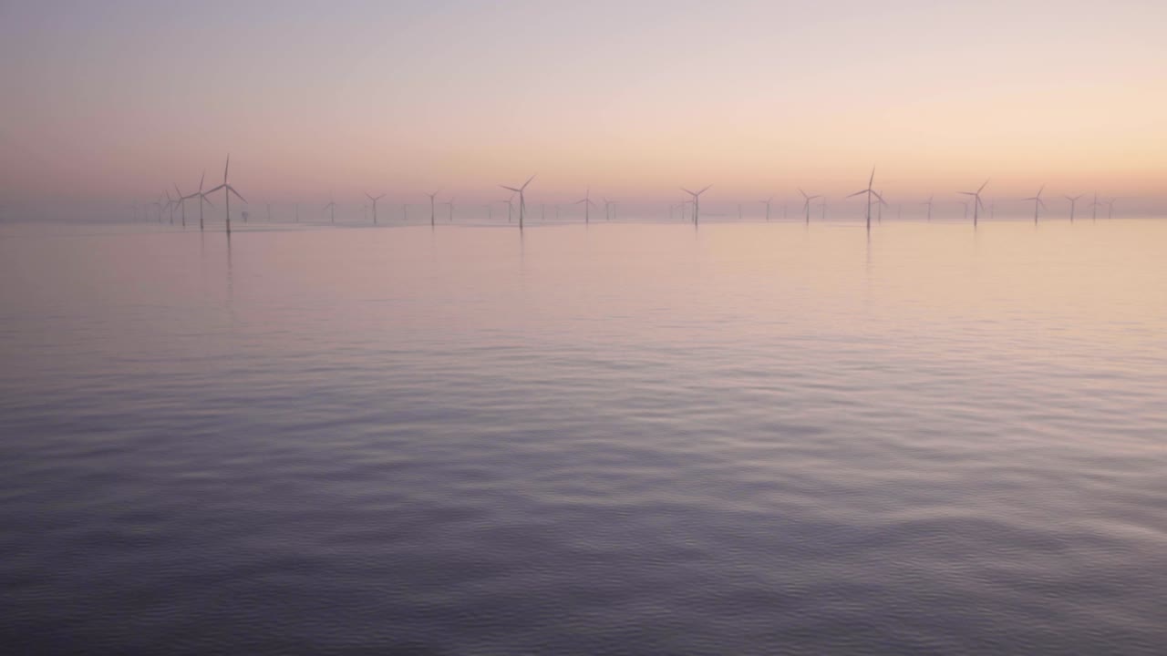 Wind turbines sail past, early morning, North Sea, English Channel.