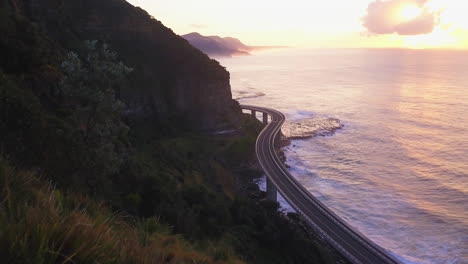 Mar-Acantilado-Puente-épico-Amanecer-Puesta-De-Sol-Conduciendo-Sobre-El-Océano-Australia-Impresionante-Costa-Material-De-Anuncio-De-Televisión-Dron-De-Taylor-Brant-Película