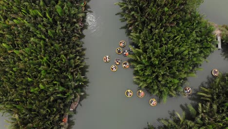 Drone-flying-above-famous-basket-boats-tour-at-Hoi-an,-aerial